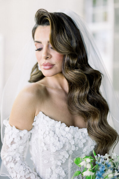 a bride in a wedding dress holding a bouquet