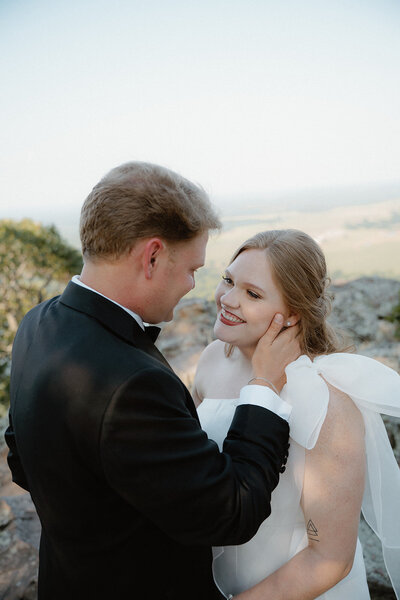 wedding photo of bride and groom looking at each other