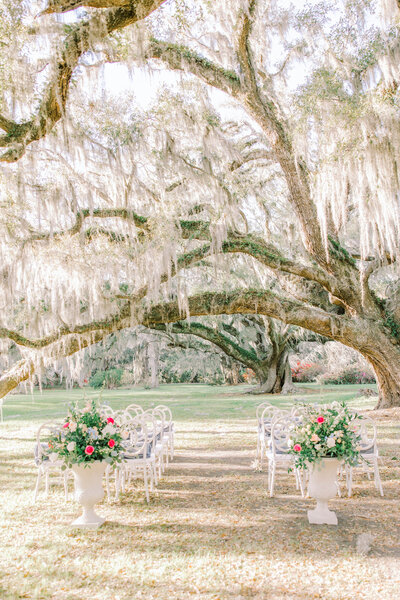 Magnolia Wedding ceremony florals beneath a grande angel oak located just outside Charleston, SC