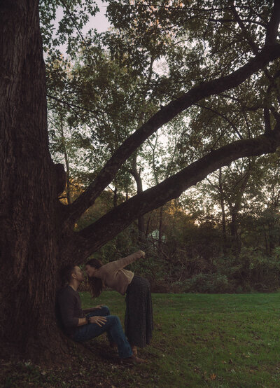 woman leans down to kiss husband