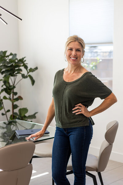 Laura Bogart posed at dining table with laptop