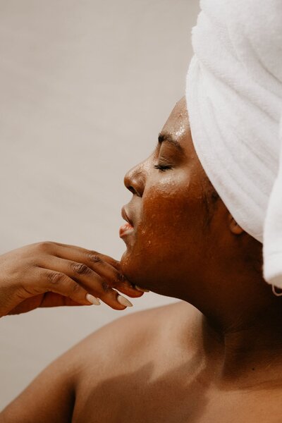 Woman gently touching her face