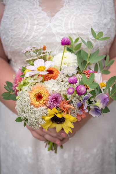 bridal bouquet ifull of wild flowers n bride's hands