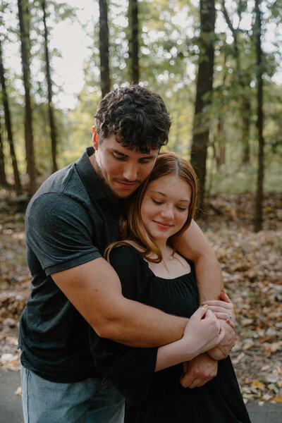 photo of couple hugging in the woods