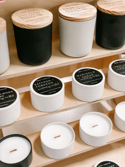 black and white candles displayed on wood shelf