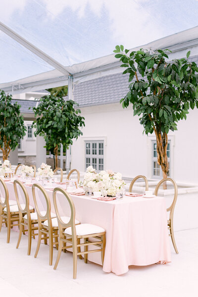 gold chairs next to pink table cloth