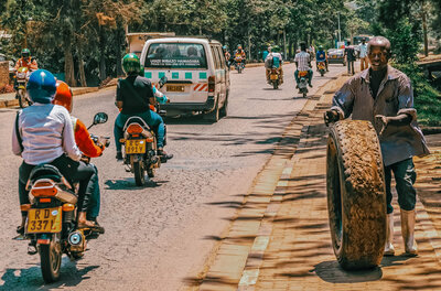 Motorcycles and a police van driving through the streets of Kigali, Rwanda