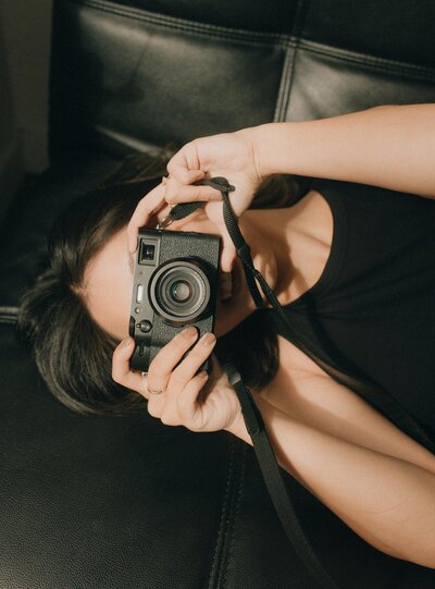 girl holding up camera and smiling