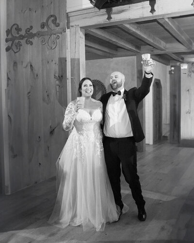 Wedding photo of a happy couple cheering at the Seclusion wedding venue in Lexington Virginia