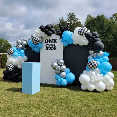 The custom touch that makes our black and white boys-themed backdrop and decor rental perfect for adding flair to your extraordinary outdoor event.