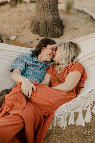 couple snuggling in a hammock together
