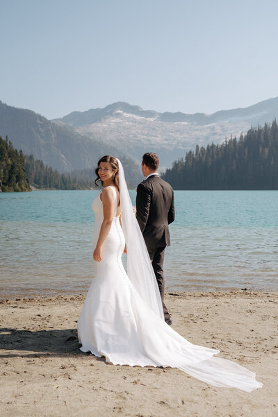 An elopement wedding on the lakeshore with a scenic mountain view
