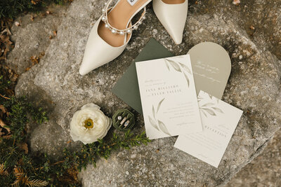 Wedding invites and rings flat lay with greenery styled by KR Occasions