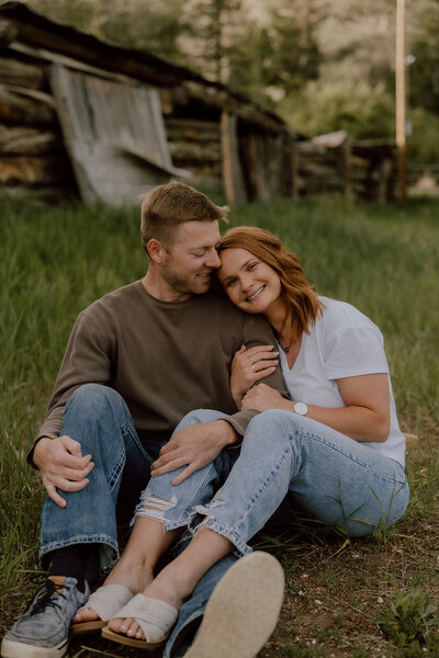 Engagement photo of a couple at sunset in Wyoming, with a romantic outdoor setting and soft natural lighting.