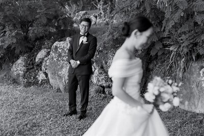 A person smiling at looking at their partner on their wedding day 