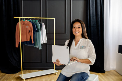 Business owner working on tablet in natural light photography studio