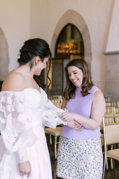 wedding planner fixing a bride's sleeve