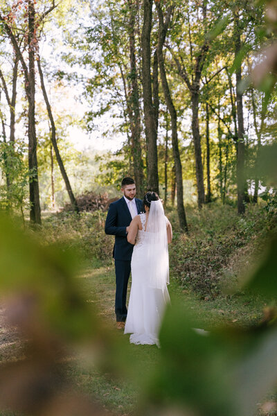 Tattooed couple sharing a candid moment during their alternative wedding in Springfield, MO, photographed by Chelsea Stanford.