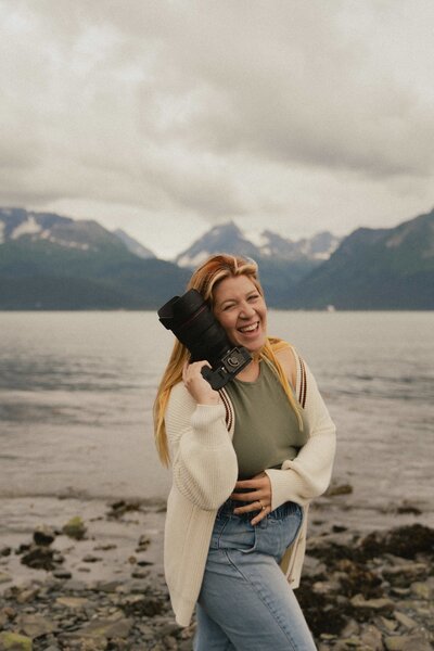 Jamie holds a camera outdoors