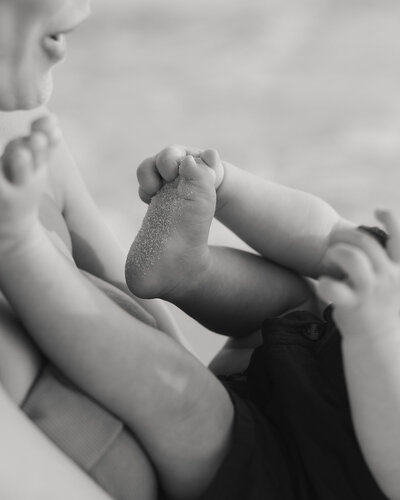 baby plays in the sand