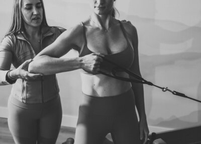 Two women on Pilates reformers