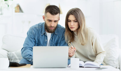 young-couple-planning-family-budget-with-laptop-UWABLNY