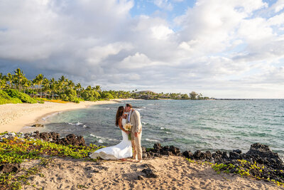 couple kissing on beach by team of big island wedding photographers from Hawaii Adventure Portraits