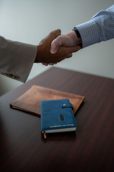 Columbus Ohio family law attorney shaking hands with a client, symbolizing progress toward resolution