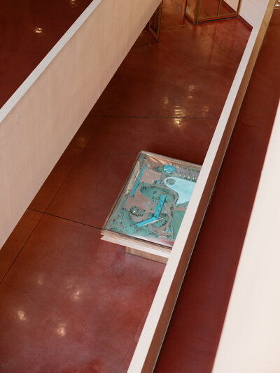 Map book on red bench inside Marin Civic Center, film photo.