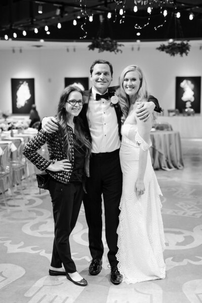 Meg Owen standing with a bride and groom on their wedding day