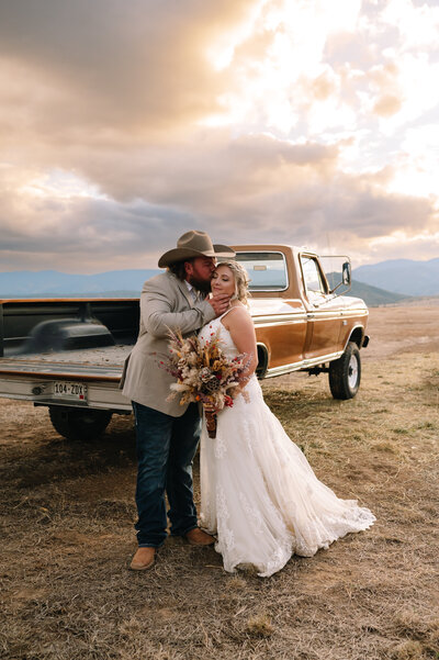 Couple standing in front of truck