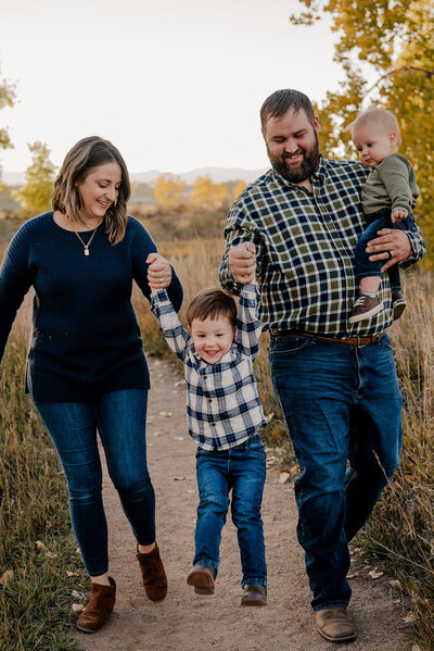 Parents smile at their son during their family photo session