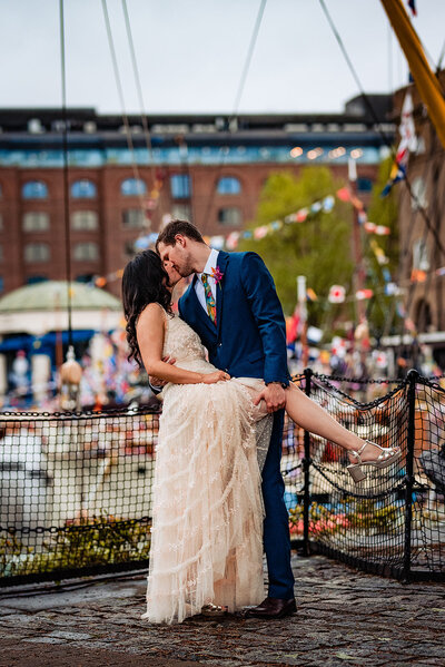 Bride is wearing a black dress and holding bry flowers