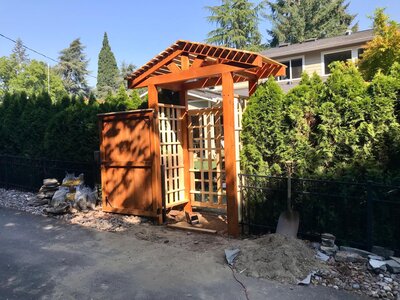 Wooden arbor with lattice design built for backyard shade and structure