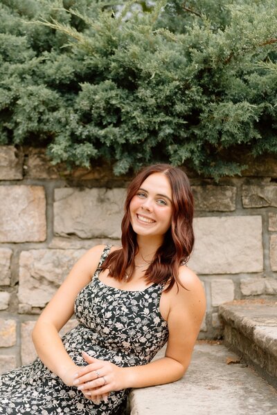 girl leans against staircase for senior photos