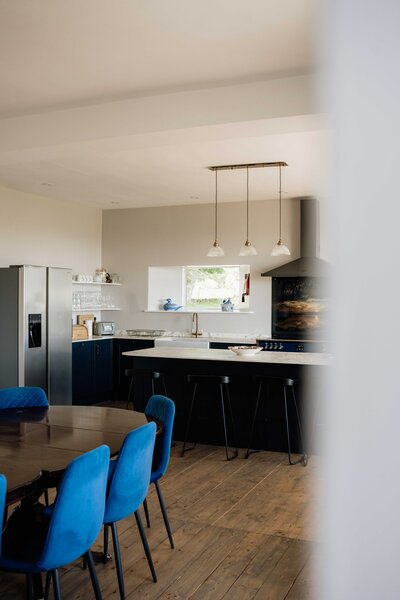 A modern self-catering kitchen is photographed through a window at Kinclune House.