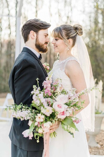 bride and groom hugging with bouquet