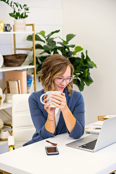 Elizabeth Rose, a certified holistic nurse and wellness coach, talking to a client through a laptop, providing compassionate guidance and holistic care during an online consultation.
