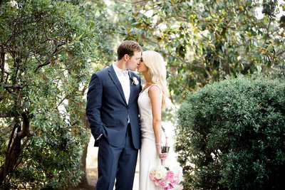 Bride and groom snuggle at the Rice Mill Building, Charleston Wedding Photographer