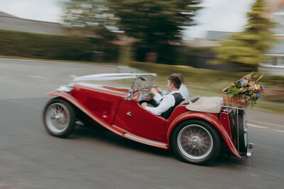 Wedding car moving towards receptio captured with motion blur