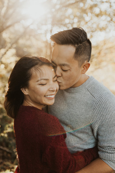 Man kisses his fiance's cheek during their Oregon engagement photography session