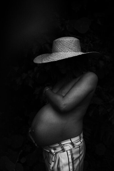 A black and white maternity portrait of a woman showing her bump in Auckland by Eilish Burt Photography