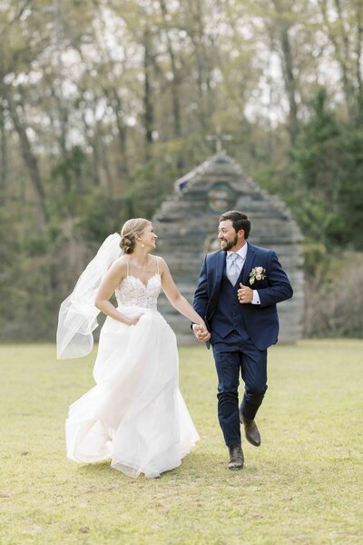 bride and groom running together in wedding attire
