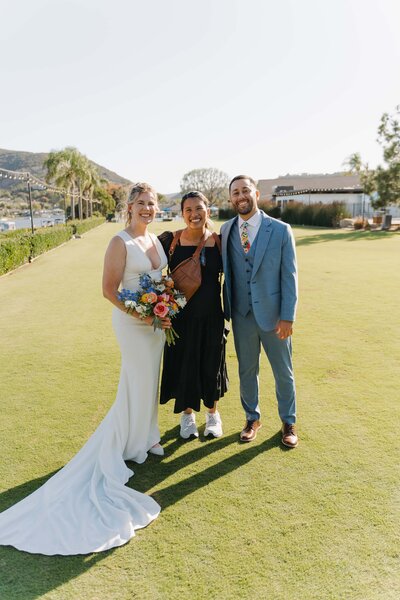 photographer posing with couple