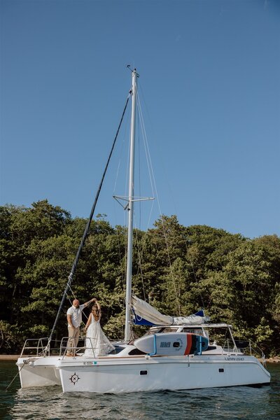 bride and groom dancing on a sailboat on Lake Superior
