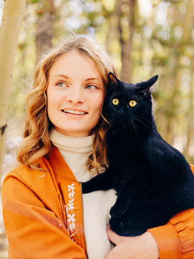 Girl holding a black cat in Fairplay