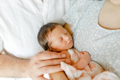 Photo by South Shore Photographer Christina Runnals | A newborn baby being held by her parents.
