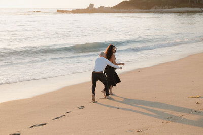 Candid documentary engagement session photos during sunset orange county california
