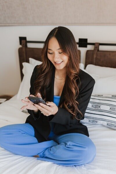 Professional brand designer calling a client to review web design for service-based businesses.