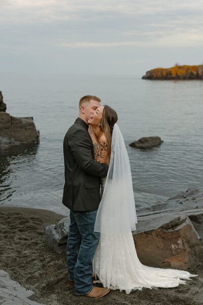 Couple exchanging vows during an intimate Minnesota elopement with natural scenery in the background.